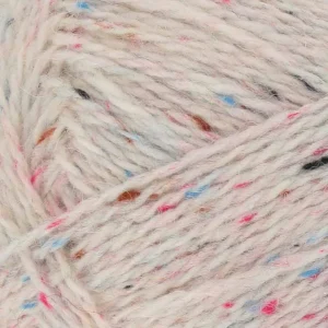 Close-up of pale pink yarn with multicolored specks in blue, pink, and orange.