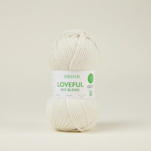 Cream-colored ball of yarn with a white label reading 'LOVEFUL BIO BLEND' in green, brand SIRDAR visible, on a light neutral background.