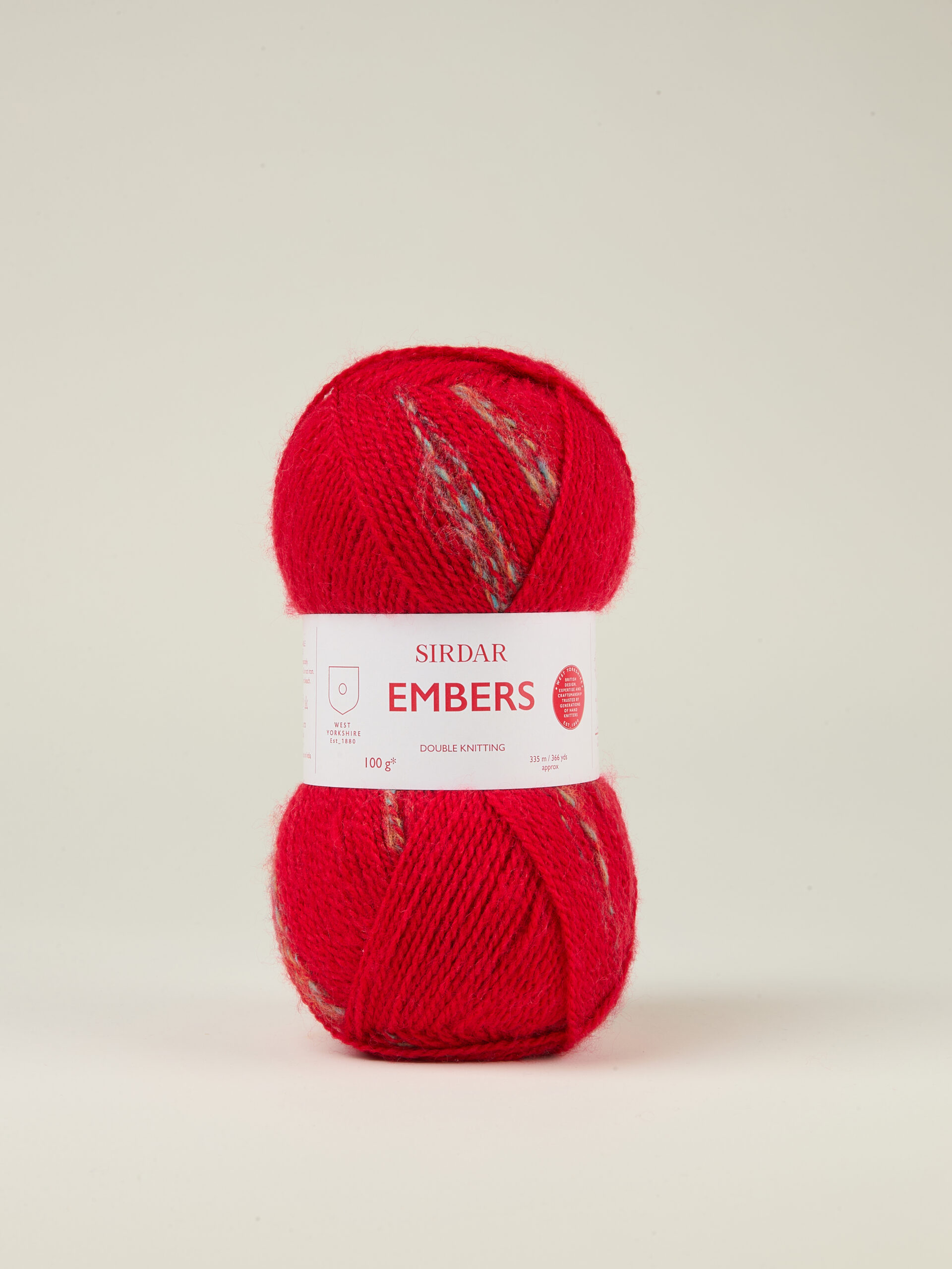 F266-0402 Bonfire Red skein of yarn with a white label around the middle reading 'SIRDAR EMBERS' against a pale background.