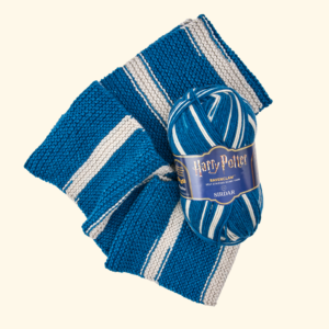 Blue and cream striped knitted scarf with a Harry Potter Ravenclaw label against a pale background.