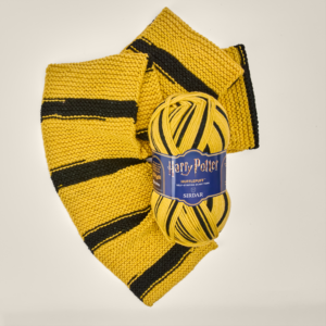 Yellow and black striped knitted scarf with a Harry Potter Hufflepuff label visible.