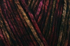 Close-up of multicolored yarn fibers overlapping in deep reds, purples, and gold.