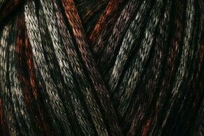 Close-up of dark brown to black hair with subtle red highlights and visible strand texture.